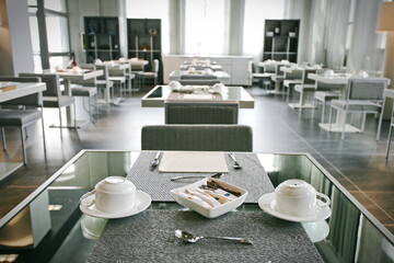 Fototapeta na wymiar Breakfast room of an empty hotel due to absence of guests. Milan, Italy - April 2020