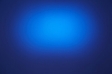 On a dark blue background, a blue oval cloud of light