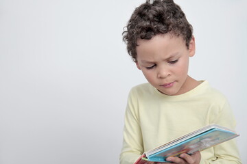 boy with school book going back to school on white background stock photo