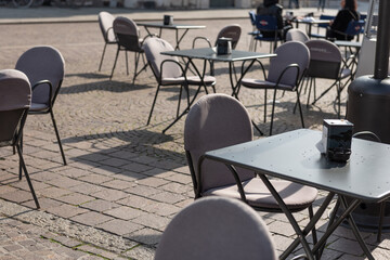 Close-up of empty iron table in outdoor restaurant or cafe. Lockdown times.