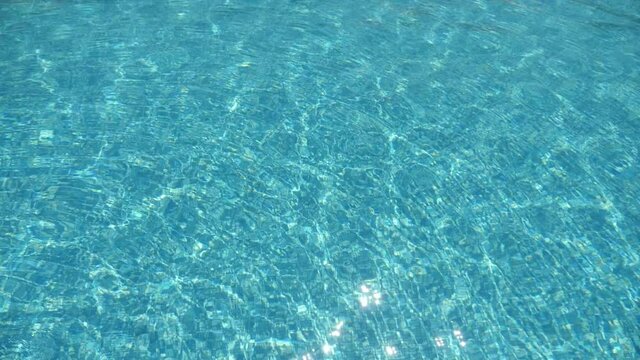 Celeste waves are swaying calmly in swimming pool in a sea resort in summer