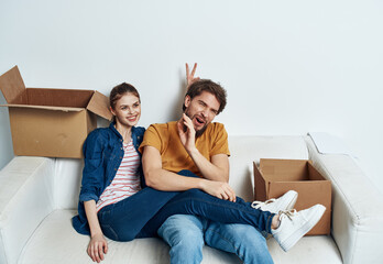 Fototapeta na wymiar Man and woman in a new apartment boxes with things interior