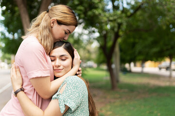 Fototapeta premium Young gay couple hugging and kissing in a park