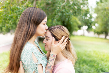 Profile of a young woman kissing her girlfriend