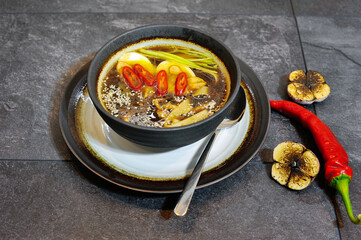 Delicious home cooked food with steam on table on brown background
