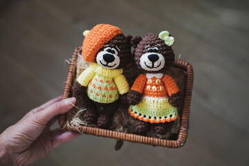 Handmade knitted soft toy. Amigurumi. Small  teddy bears   on the wooden background. Crochet stuffed animals. Couple