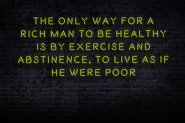 Wise quote. Neon inscription against brick wall