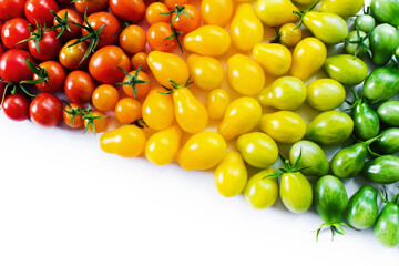 The harvest of tomatoes. Different color and varieties of tomatoes on a white background. Healthy and natural food. Vertical	
