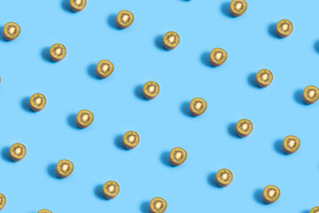 Fresh kiwis halves pattern on a blue background
