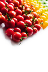 The harvest of tomatoes. Different color and varieties of tomatoes on a white background. Healthy and natural food. Vertical	