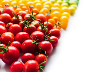 The harvest of tomatoes. Different color and varieties of tomatoes on a white background. Healthy and natural food. Vertical	