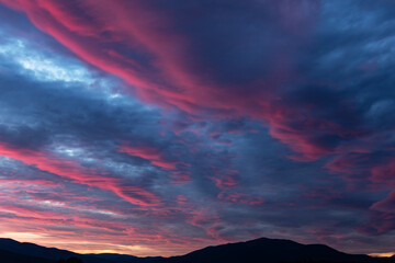Fiery purple sunset sky. Dramatic sky with pink glowing clouds. Natural background for your landscape project