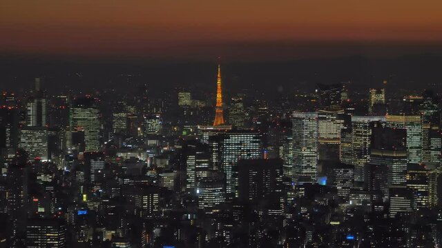 The yellow tower in the middle of Tokyo Japan with the city lights all over at night time