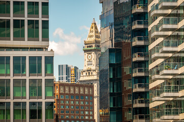 Fototapeta premium An historic Boston skyscraper, through the new glass buildings of the Seaport