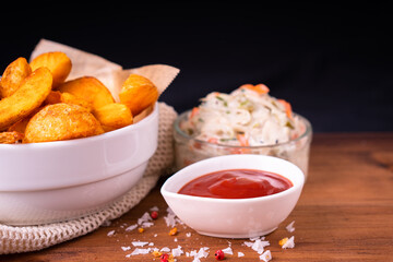Tradition french fries from organic bio potato wedges with skin dip in ketchup