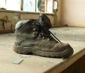 Solitary dirty work boot on a bench