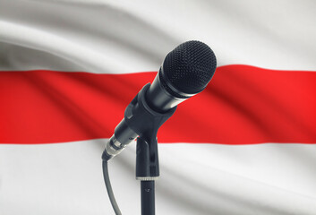 Microphone on stand with national flag on background - Belarus