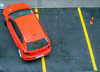 Bad parking. Improperly parked car. Cars in the parking. View from above. red car