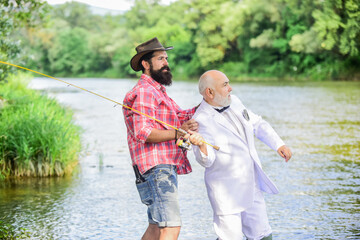 He must use it. retired businessman. male friendship. family, granddad and drandson fishing. hobby and recreation. two fishermen with fishing reel. mature man fisher celebrate retirement