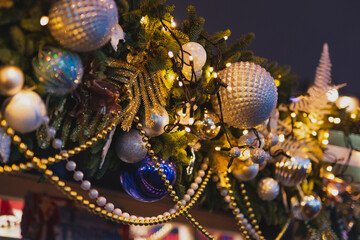 Fototapeta na wymiar New Year decorations. Closeup Christmas lights and balls on the street