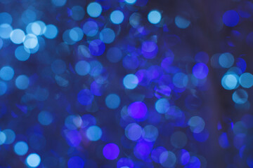 Abstract blue background. Blurred and defocused flickering Christmas lights
