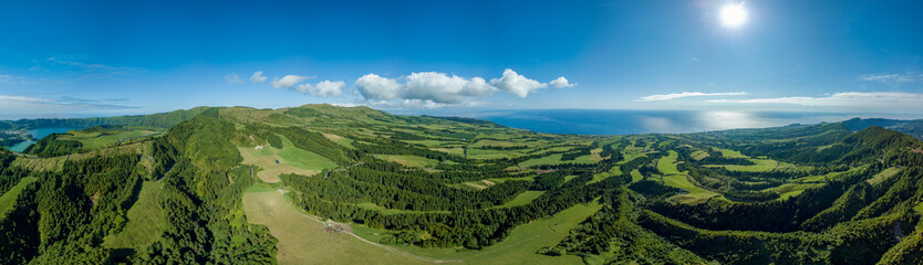Fototapeta na wymiar Panoramic view over the luxurious green landscape and the Atlantic ocean, in the zone of Sete Cidades, São Miguel island in the Azores.