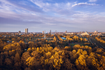 Obraz premium Aerial view of Riga city at colorful sunset. Beautiful architecture, impressive trees in autumn colors. Sustainable city.