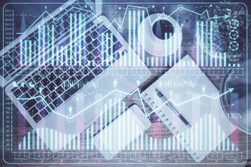 Financial market graph and top view computer on the desktop background. Double exposure. Investment concept.