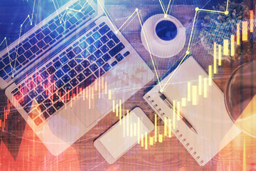 Financial market graph and top view computer on the desktop background. Double exposure. Investment concept.