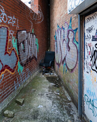 Office chair at end of graffiti alleyway
