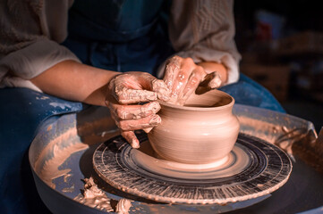 The hands of the master who makes the jug. Close-up.