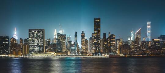 New York City Cityscape during Night Time with busy skyline and dense vibrant skyscrapers filling up the sky and lighting up the city