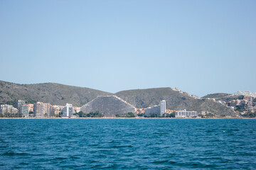 Fototapeta premium Panoramic view from the sea, of the holiday town of Cullera in Valencia, southern Spain.