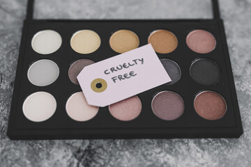 cruelty free vs animal tested cosmetics eyeshadow palettes with text on labels
