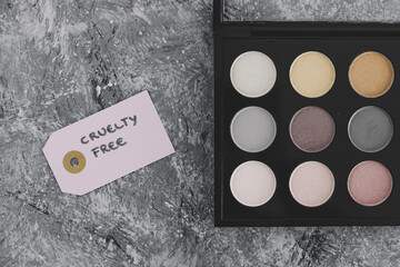 cruelty free vs animal tested cosmetics eyeshadow palettes with text on labels - obrazy, fototapety, plakaty