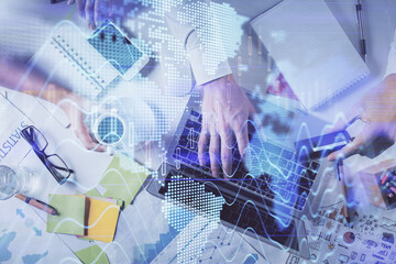 Multi exposure of man's hands typing over computer keyboard and forex graph hologram drawing. Top view. Financial markets concept.