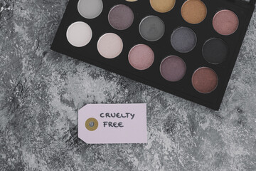 cruelty free vs animal tested cosmetics eyeshadow palettes with text on labels