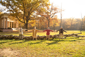 Senior people with face mask covered standing in park in distance.