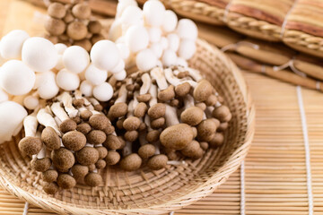 Fresh brown and white Shimeji mushroom in a woven bamboo basket, Asian mushroom
