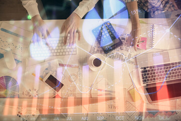 Double exposure of man and woman working together and financial chart hologram drawing. market analysis concept. Computer background. Top View.