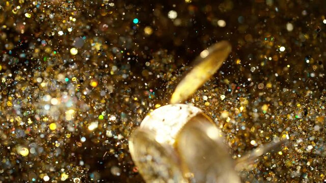Cryptocurrencies Bitcoins flying with gold shiny glitters. 4k, 1000 fps. 4k, 1000 fps, super slow motion.