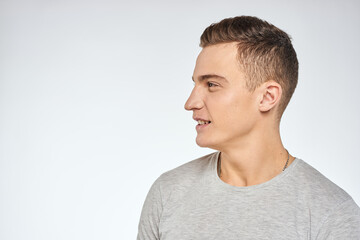 Handsome man in gray t-shirt cropped view of emotion Studio Model