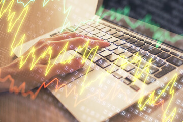 Double exposure of woman hands typing on computer and forex chart hologram drawing. Stock market analysis concept.