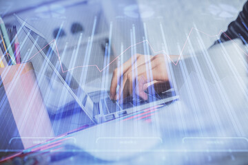 Double exposure of woman hands typing on computer and forex chart hologram drawing. Stock market invest concept.