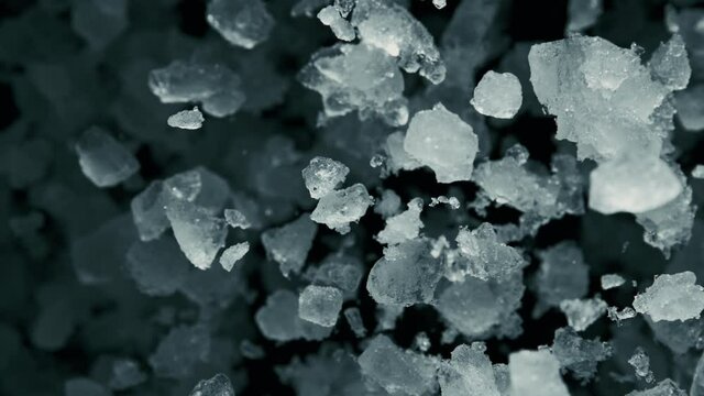 Super Slow Motion of exploding crushed ice towards camera, close-up