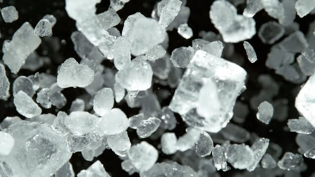 Super Slow Motion of exploding crushed ice towards camera, close-up