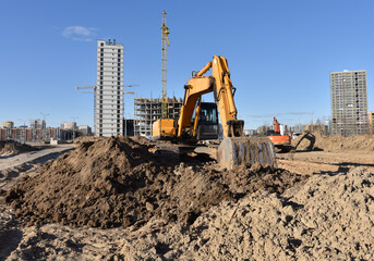 Excavator on earthworks at construction site. Backhoe on foundation work and road construction....