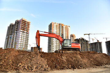 Excavator on earthworks at construction site. Backhoe on foundation work and road construction....