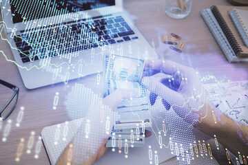 Multi exposure of financial graph drawing hologram and USA dollars bills and man hands. Analysis concept.
