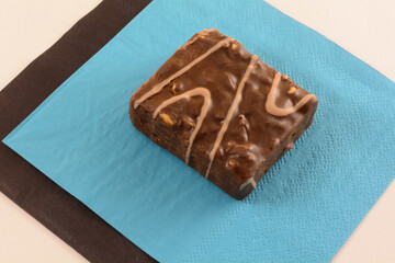 Milk chocolate wafer cake with nuts snack on blue and black napkins for sharing on white background